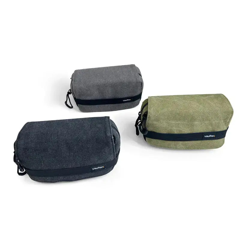 Three Vaultlax waterproof canvas pouches in dark gray, olive green, and charcoal black, arranged on a clean white background.