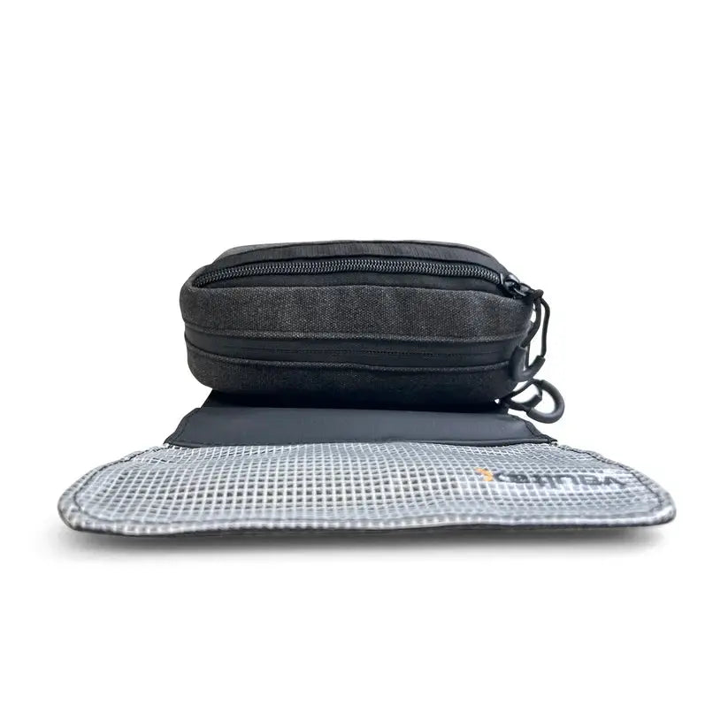 A black Vaultlax zippered pouch shown open to reveal a gray mesh interior, photographed on a clean white background.