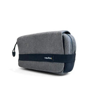 A gray textured zippered pouch with a dark navy elastic band across the front featuring the 'Vaultlax' logo, shown on a clean white background.