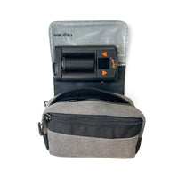 A gray and black Mighty Plus Medic portable device shown inside its zippered carrying case against a white background.
